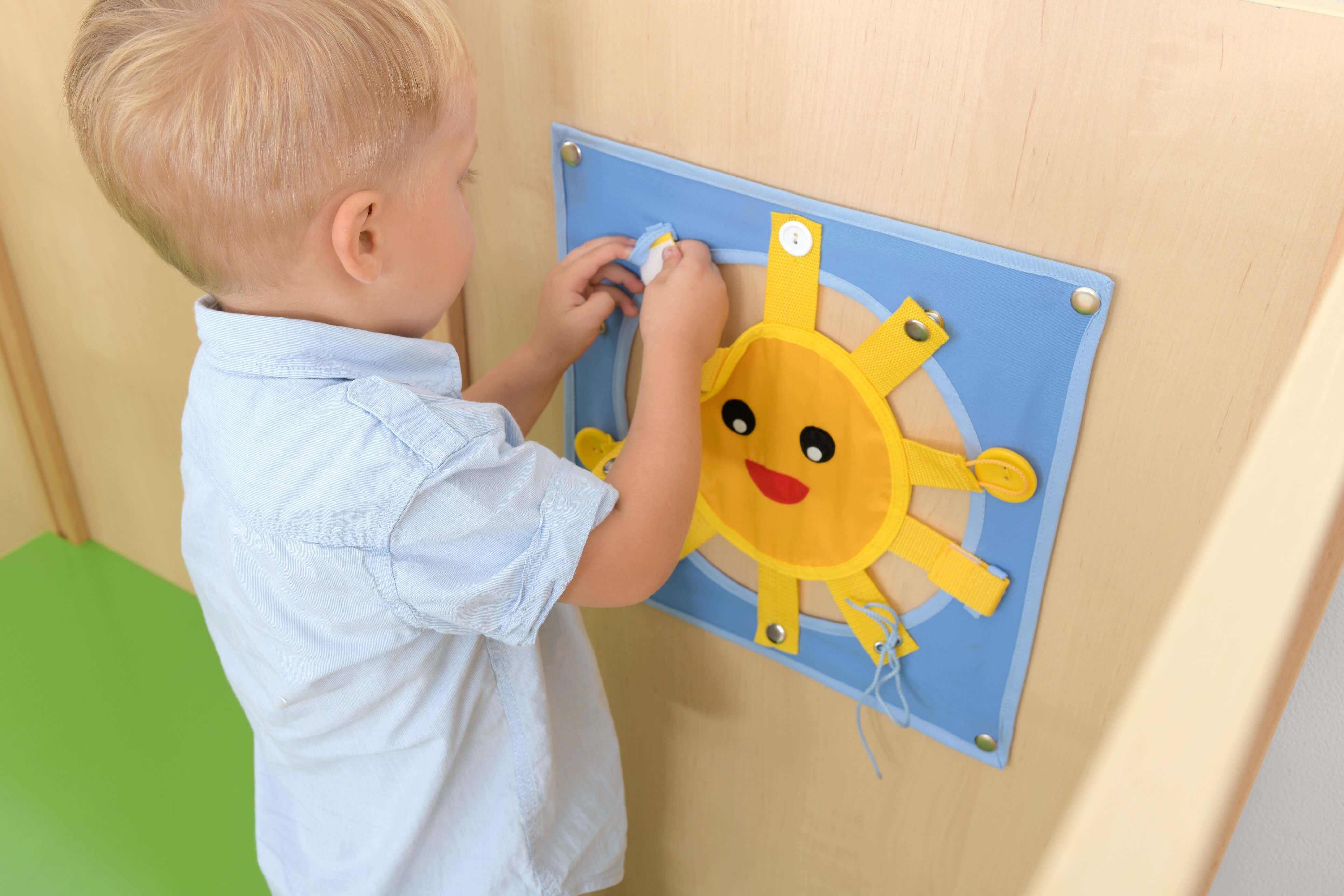 Kindergarten Spielecke Leo XL Kind spielt an Motorikwand